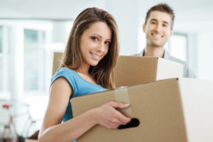 Man and lady moving with boxes, part of the home page slide show.